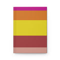 Notebook with horizontal stripes in pink, orange, yellow, and red on a white background