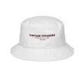 White bucket hat with 'Vintage Voyagers France' text on a white background