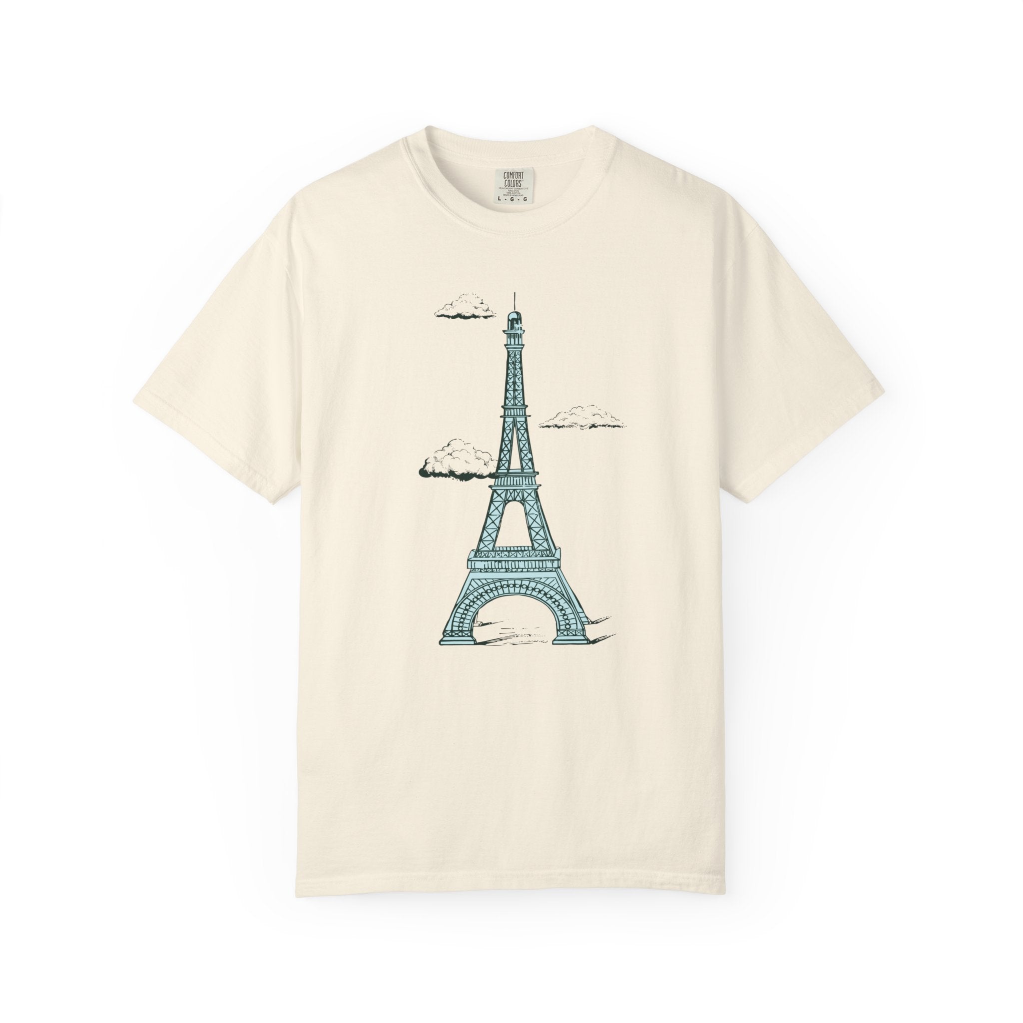 Beige t-shirt with a blue Eiffel Tower graphic on a white background