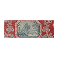 Decorative table runner with floral patterns and a central design on a red background