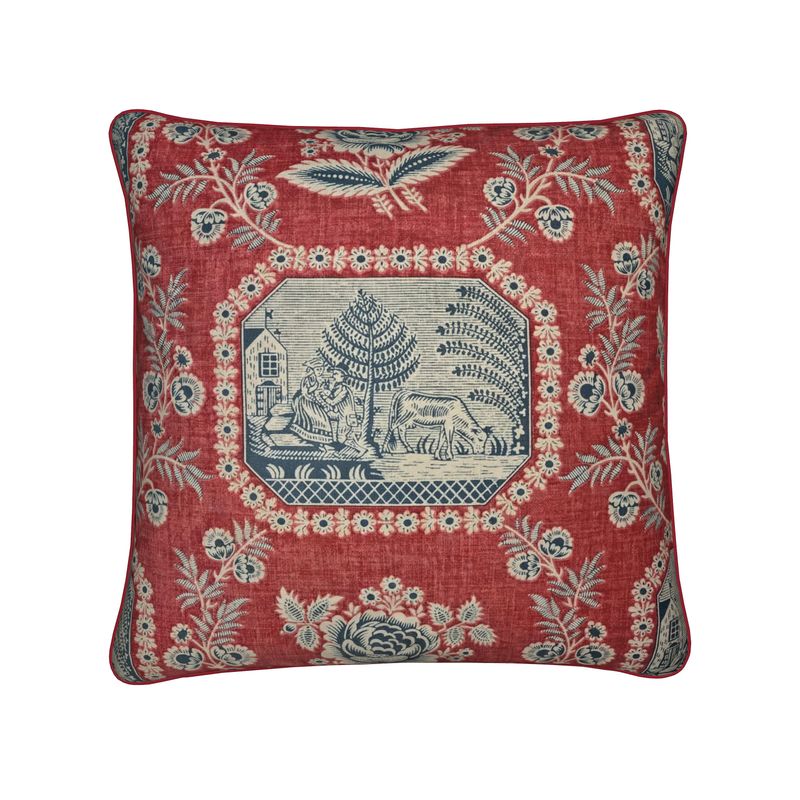 Decorative pillow with floral patterns and central design on a red background