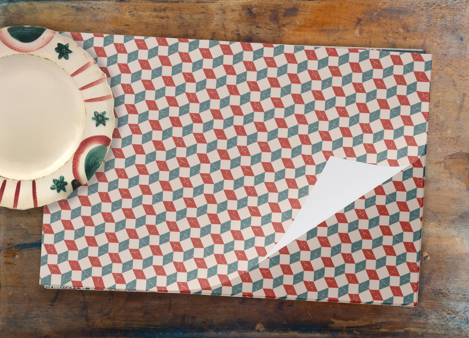 Patterned placemat on a wooden table with a ceramic plate
