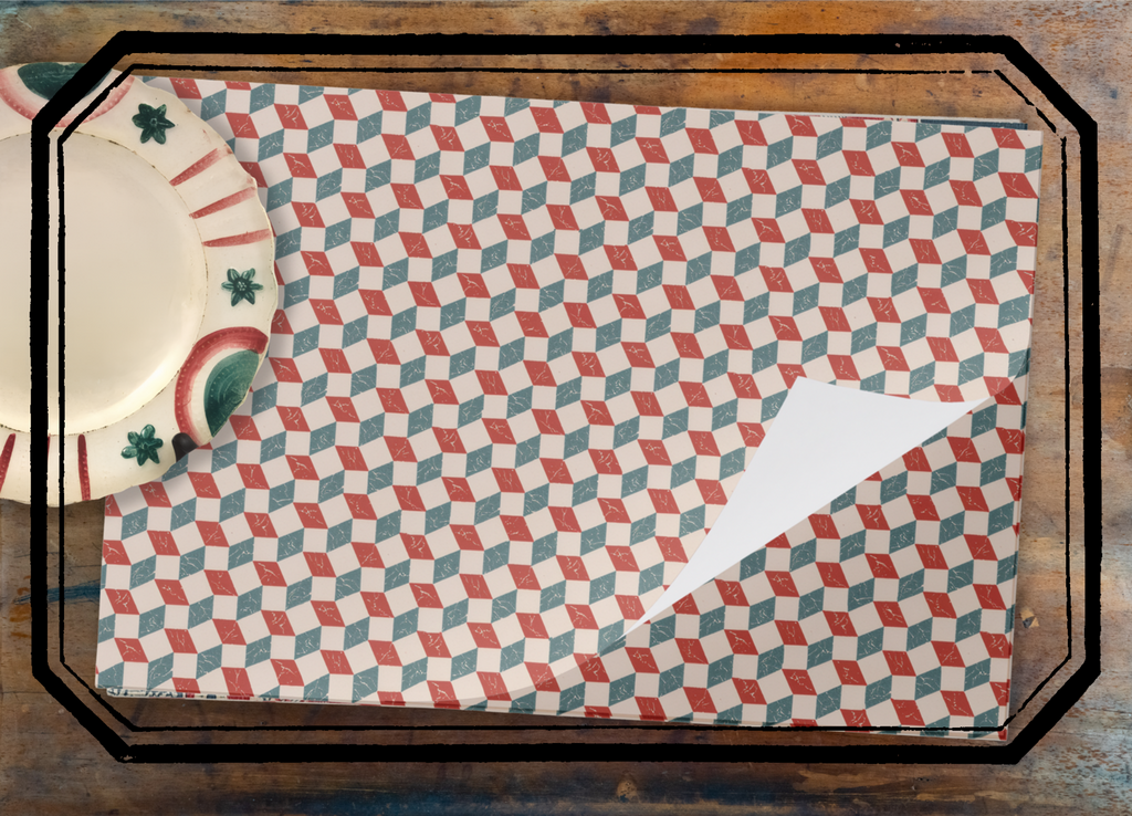 Patterned placemat on a wooden table with a ceramic plate