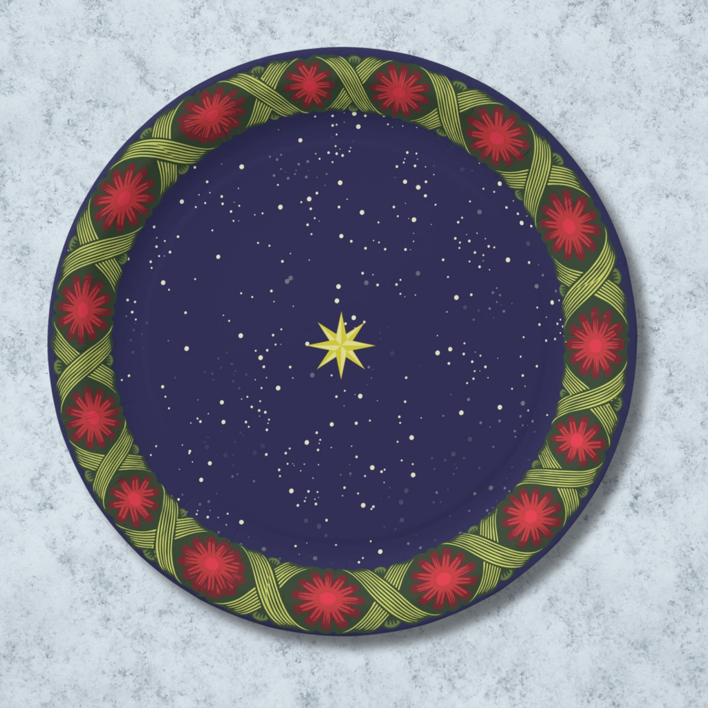 Noël La Tresse 9″ dinner plate — gold star on a navy night sky inside a braided green band with red rosettes