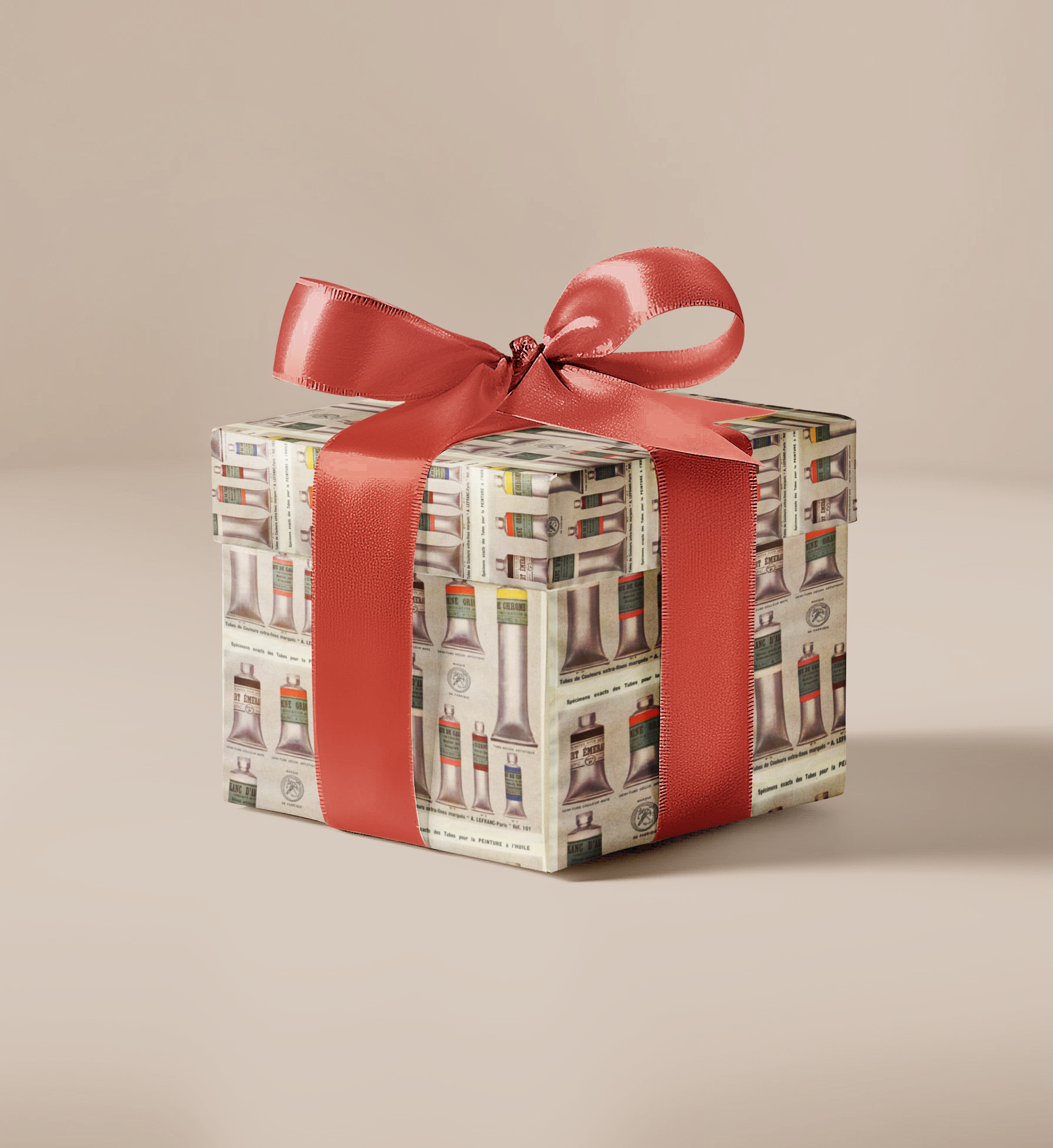 Gift box with patterned wrapping paper and red ribbon on a beige background