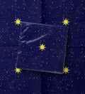 Noël La Nuit Étoilée paper napkins — gold stars scattered across deep navy, printed edge to edge