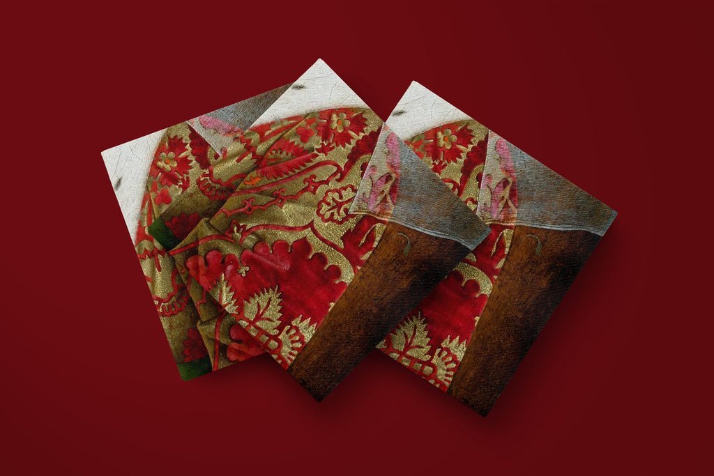 Noël Le Brocart paper napkins on a deep red ground — three napkins scattered