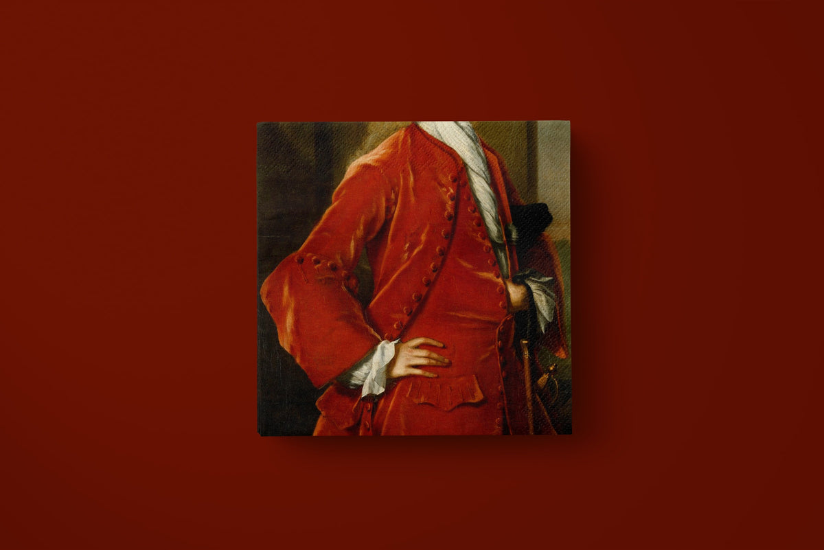 Noël L'Habit Rouge paper napkins on a deep red ground — a single napkin laid flat