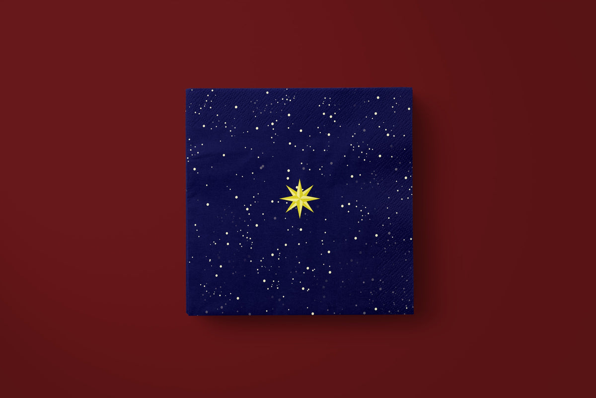 Noël La Nuit Étoilée paper napkins on a deep red ground — a single napkin laid flat