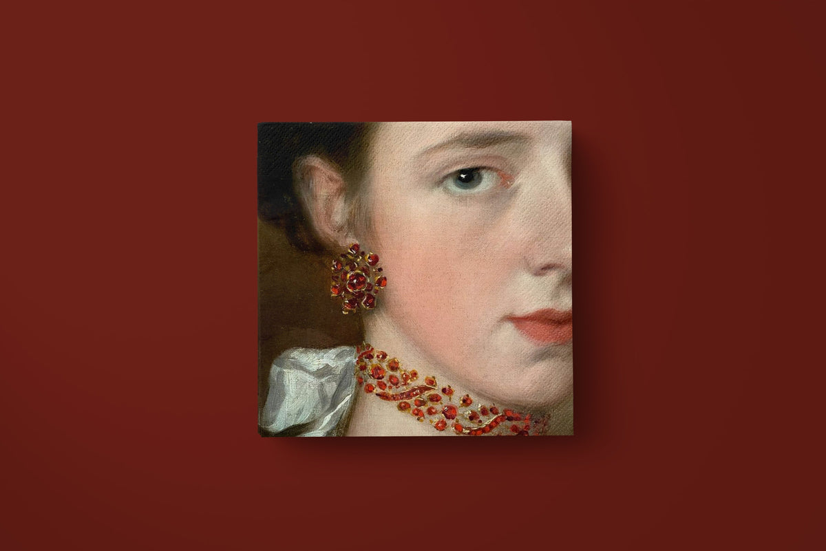 Noël La Parure paper napkins on a deep red ground — a single napkin laid flat