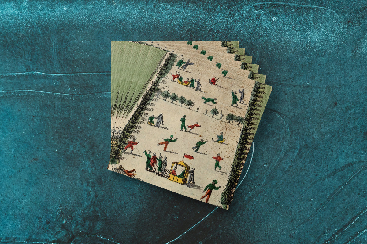Noël La Patinoire paper napkins on skating-rink ice — a fanned stack