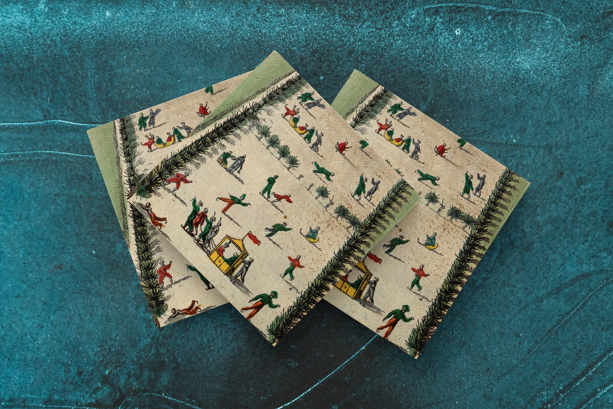 Noël La Patinoire paper napkins on skating-rink ice — three napkins scattered