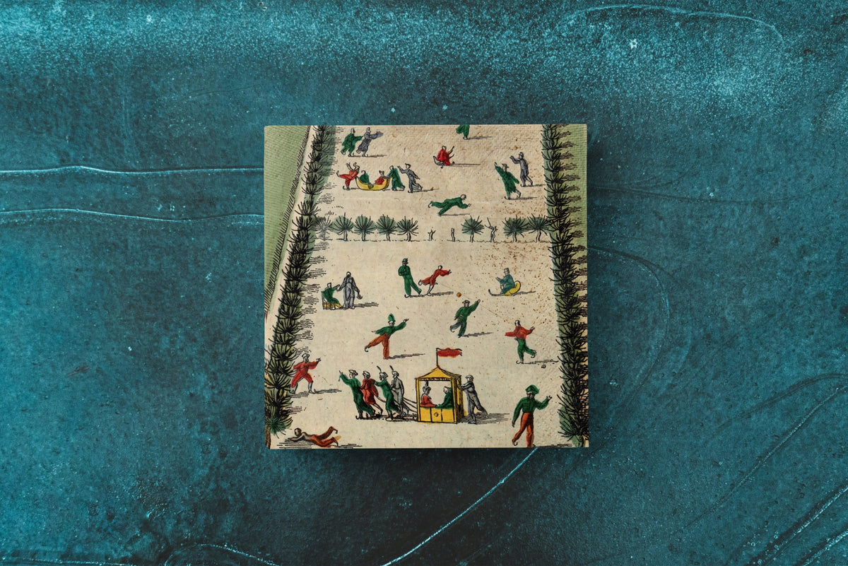 Noël La Patinoire paper napkins on skating-rink ice — a single napkin laid flat