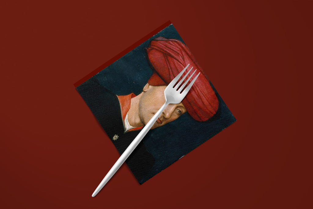 Noël Le Turban paper napkins on a deep red ground — a napkin with a fork