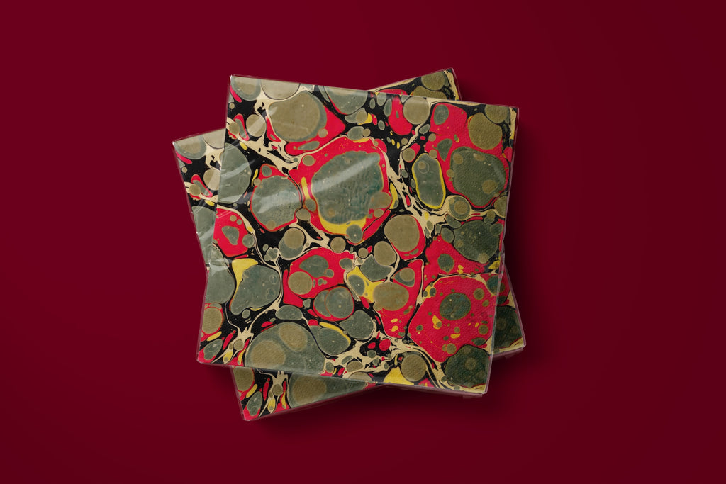 Noël Marbré Rouge paper napkins on a deep red ground — two napkins stacked