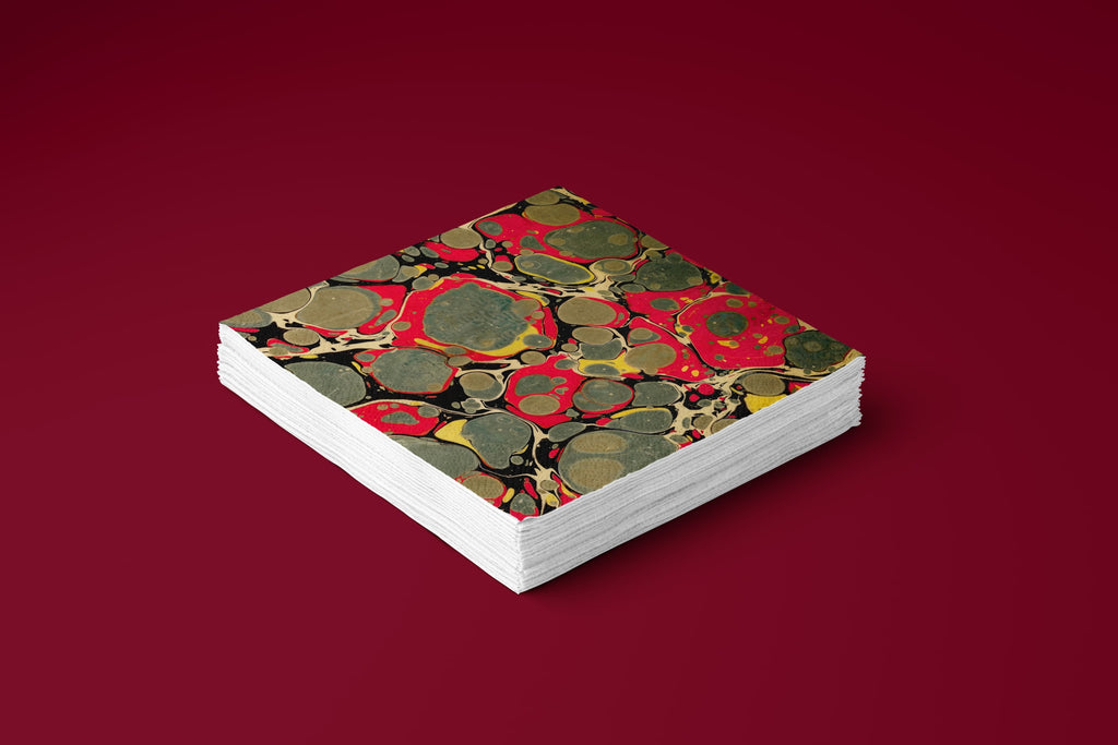 Noël Marbré Rouge paper napkins on a deep red ground — a stack of napkins