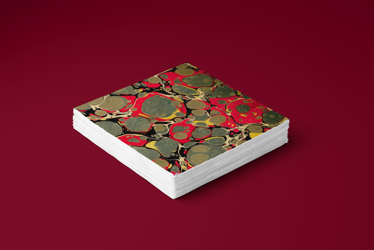 Noël Marbré Rouge paper napkins on a deep red ground — a stack of napkins