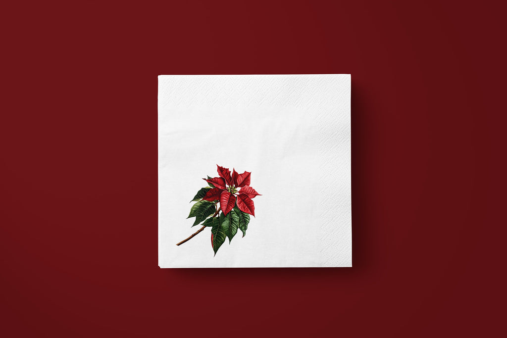 Noël Poinsettia paper napkins on a deep red ground — a single napkin laid flat