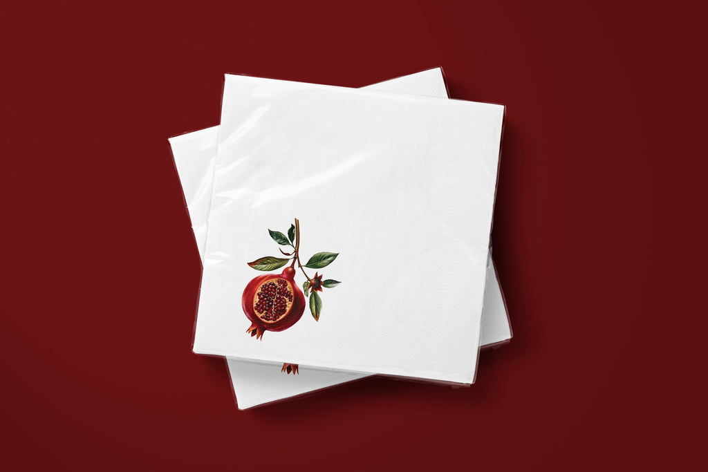 Noël Pomegranate paper napkins on a deep red ground — two napkins stacked