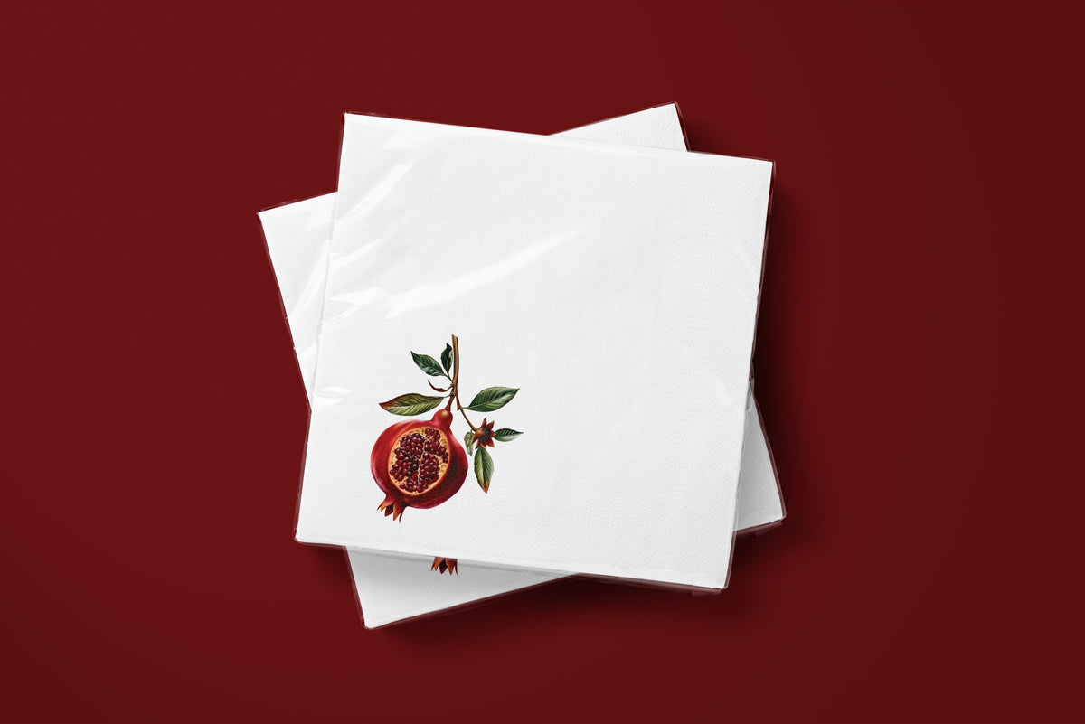 Noël Pomegranate paper napkins on a deep red ground — two napkins stacked