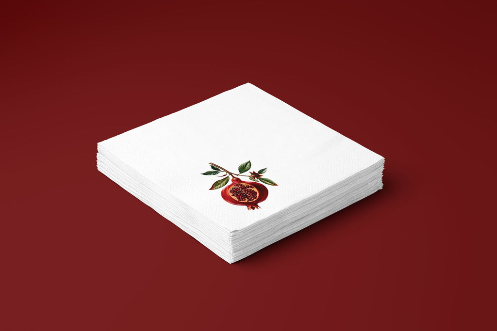Noël Pomegranate paper napkins on a deep red ground — a stack of napkins