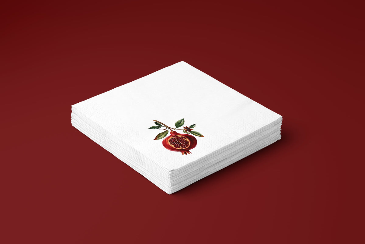 Noël Pomegranate paper napkins on a deep red ground — a stack of napkins