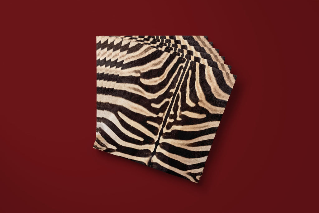 Noël Le Zèbre paper napkins fanned on a deep red ground