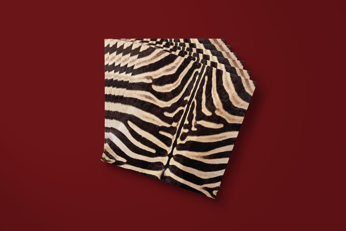Noël Le Zèbre paper napkins fanned on a deep red ground