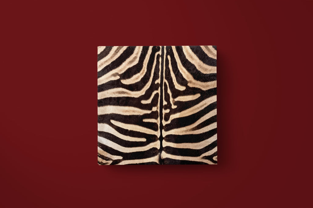 Noël Le Zèbre paper napkin laid flat on a deep red ground