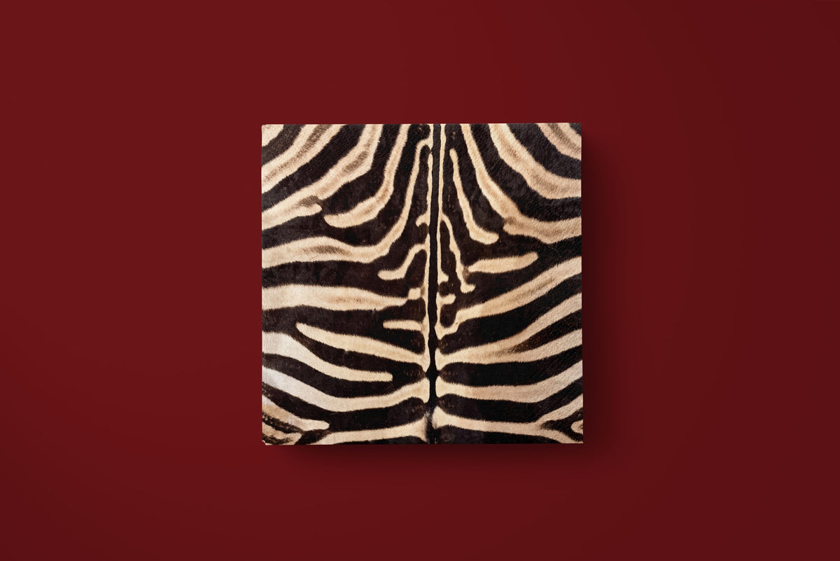 Noël Le Zèbre paper napkin laid flat on a deep red ground