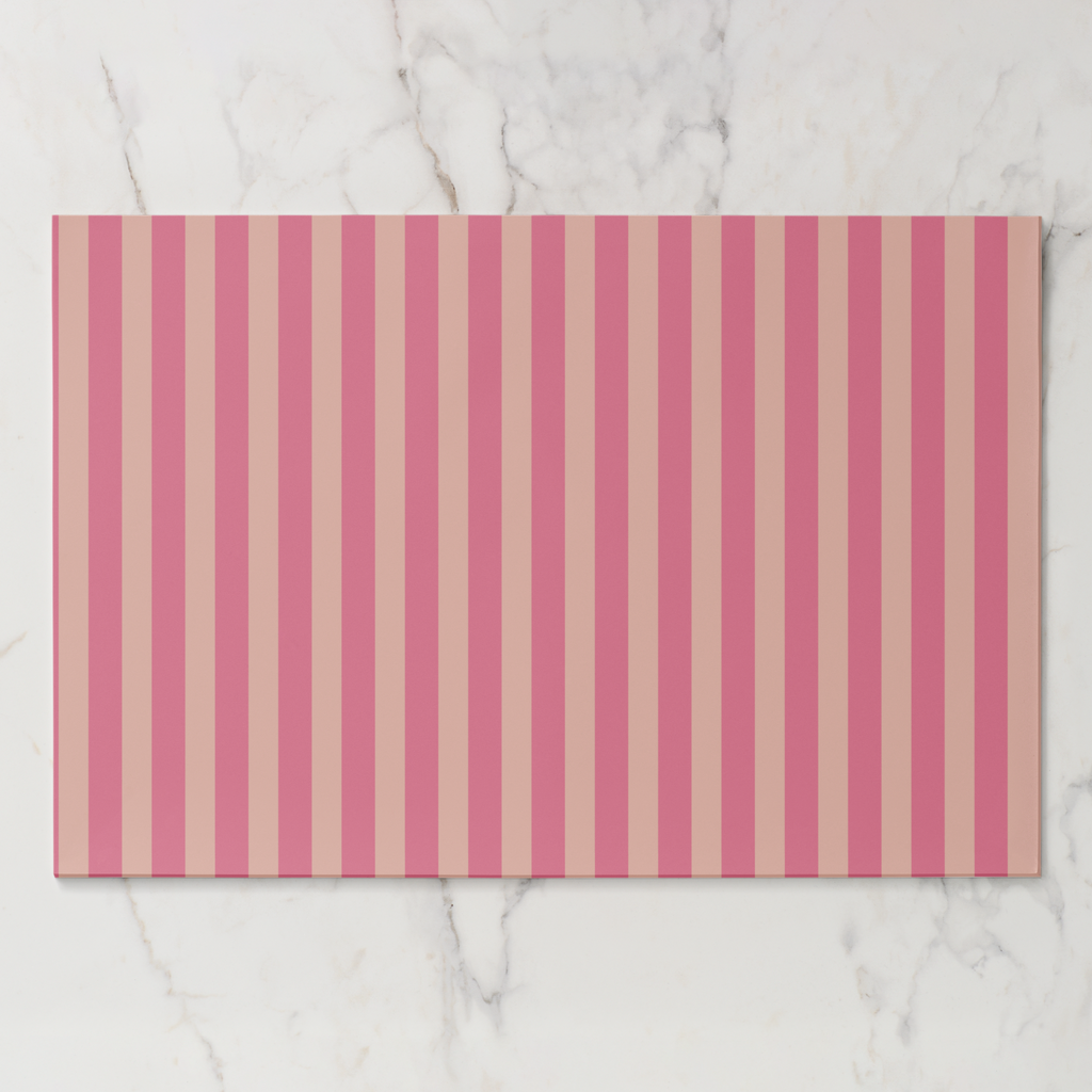 Rectangular placemat with pink and beige vertical stripes on a marble surface
