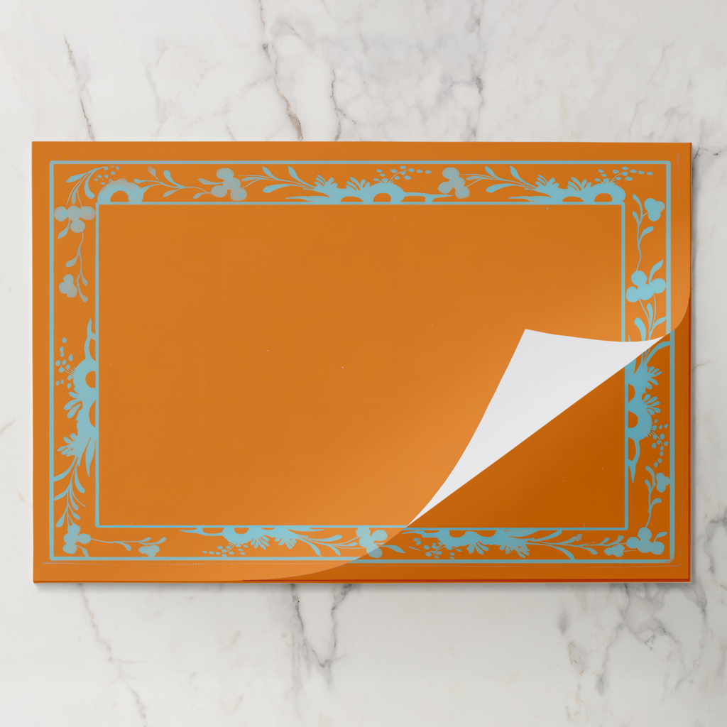 Orange Bordure placemat pad with the top sheet lifting away