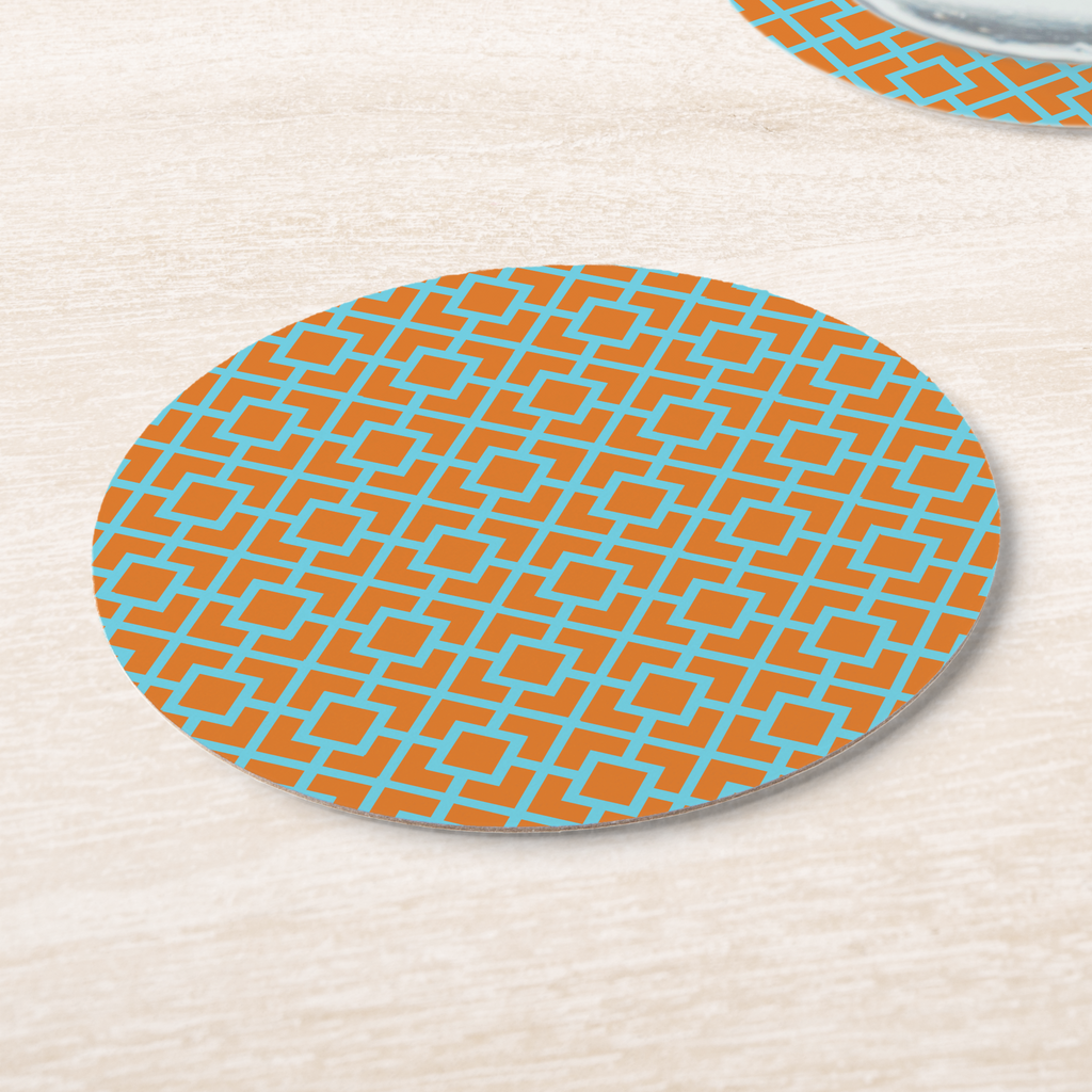 La Chinoiserie Orange Fretwork paper coasters on pale wood, aqua lattice on orange