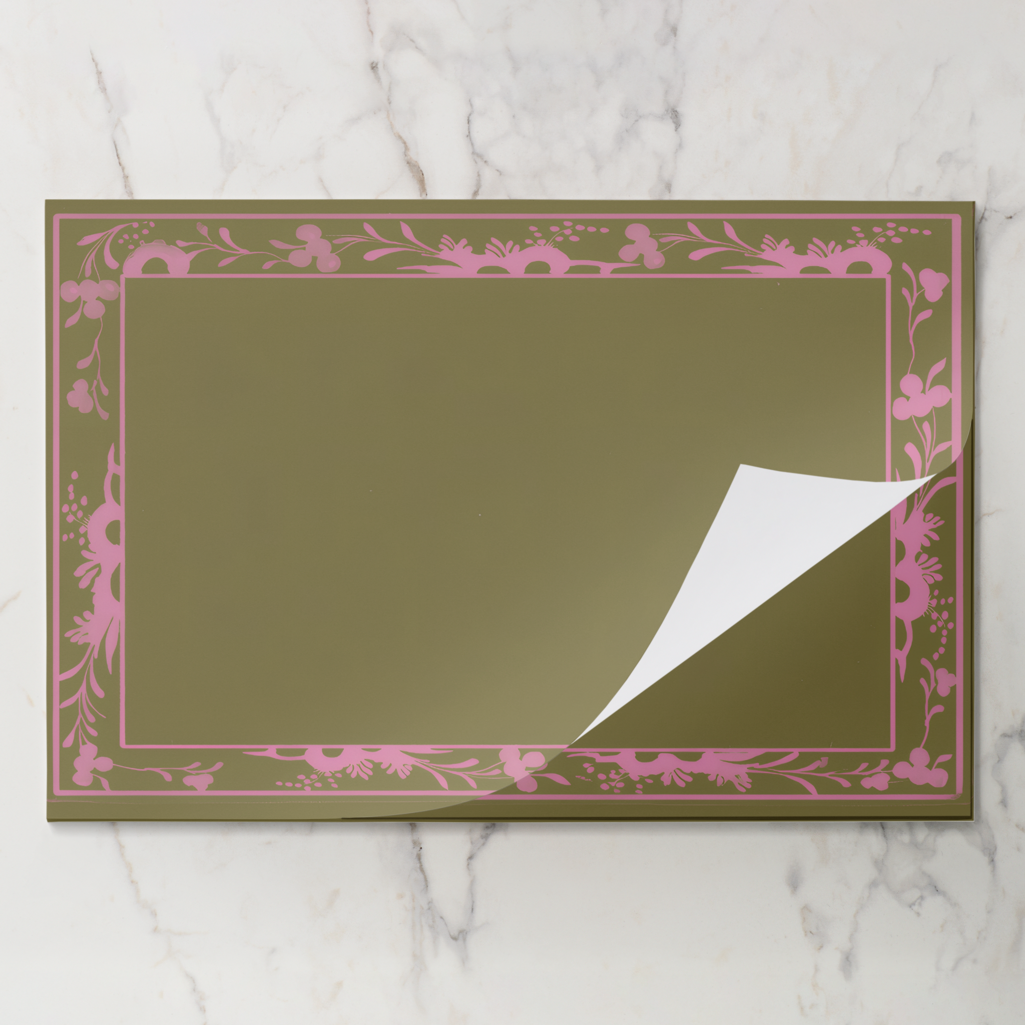 Pink Bordure placemat pad with the top sheet lifting away