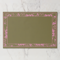 La Chinoiserie Bordure paper placemat in pink — pink engraved floral border on an olive ground