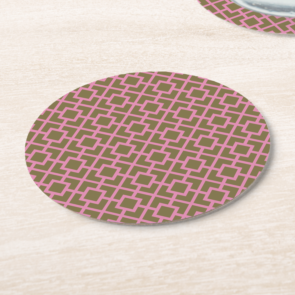La Chinoiserie Pink Fretwork paper coasters on pale wood, pink lattice on olive