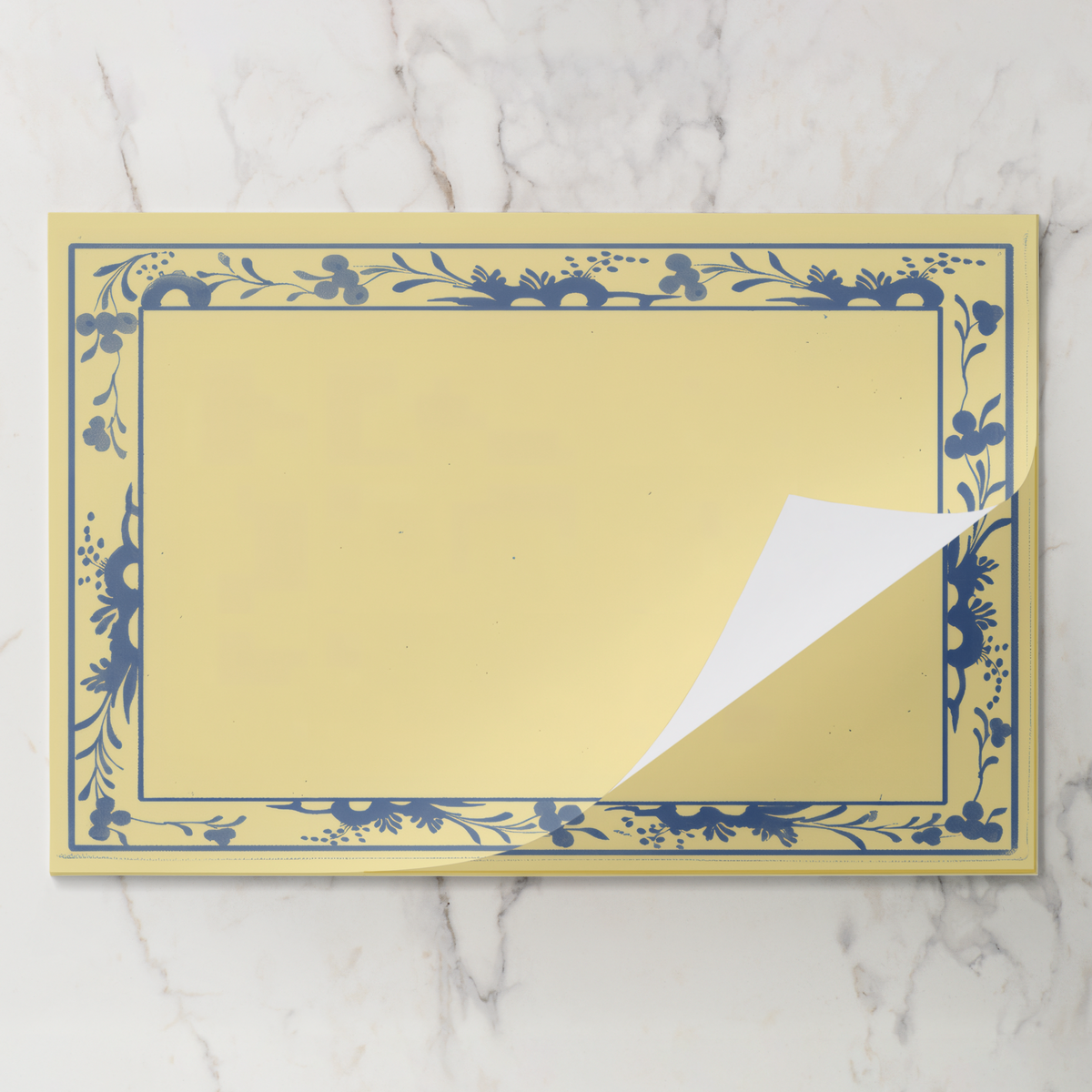 Porcelain Bordure placemat pad with the top sheet lifting away