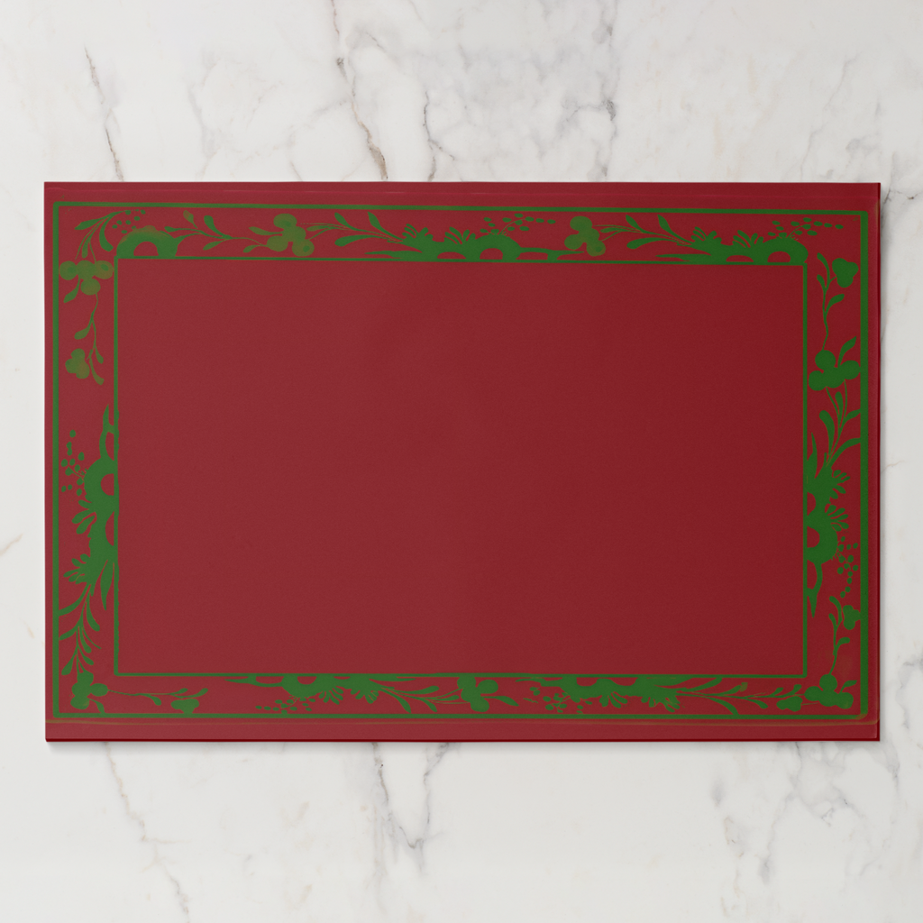 La Chinoiserie Bordure placemat pad in Noël — engraved border with an open centre, green on red
