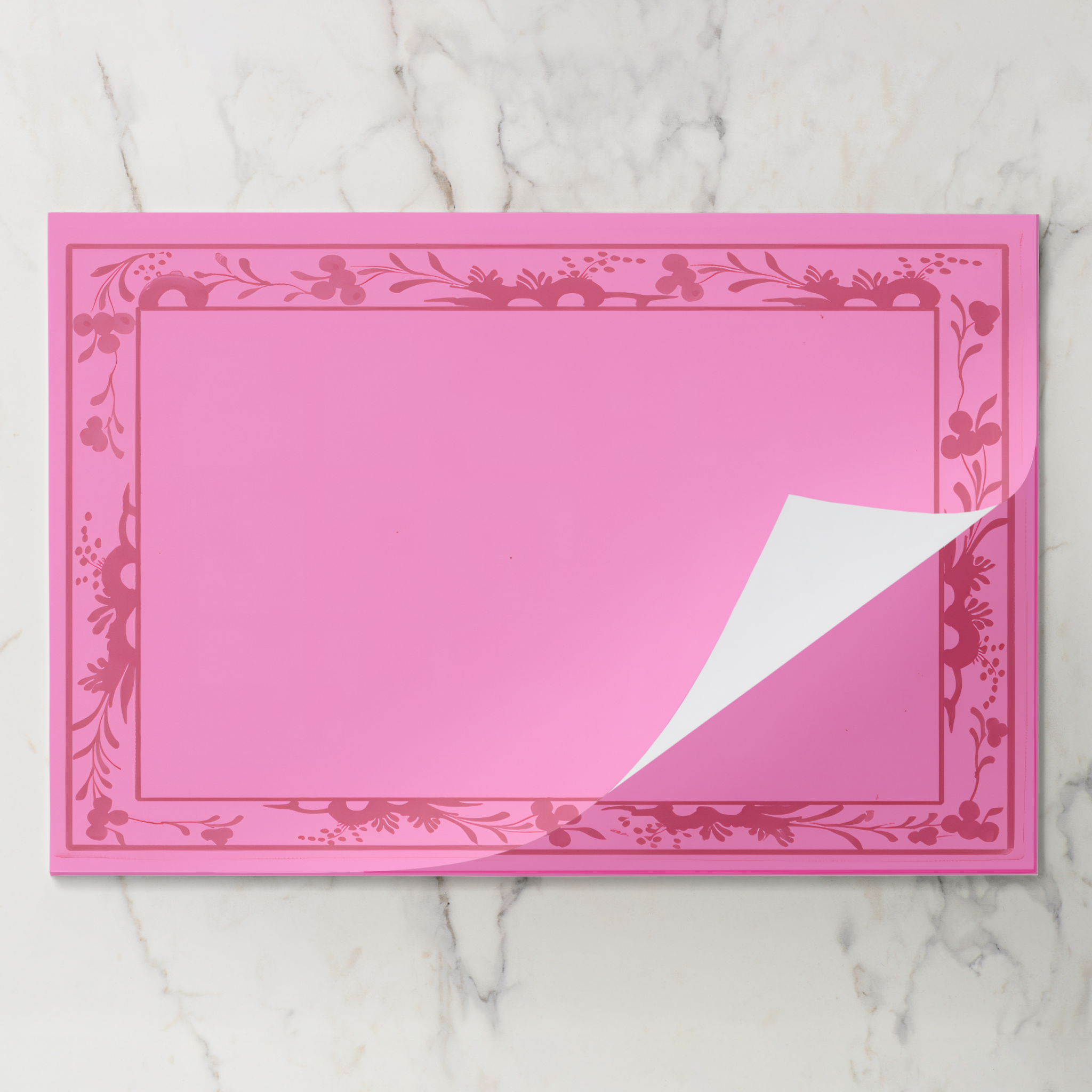 Rouge Bordure placemat pad with the top sheet lifting away