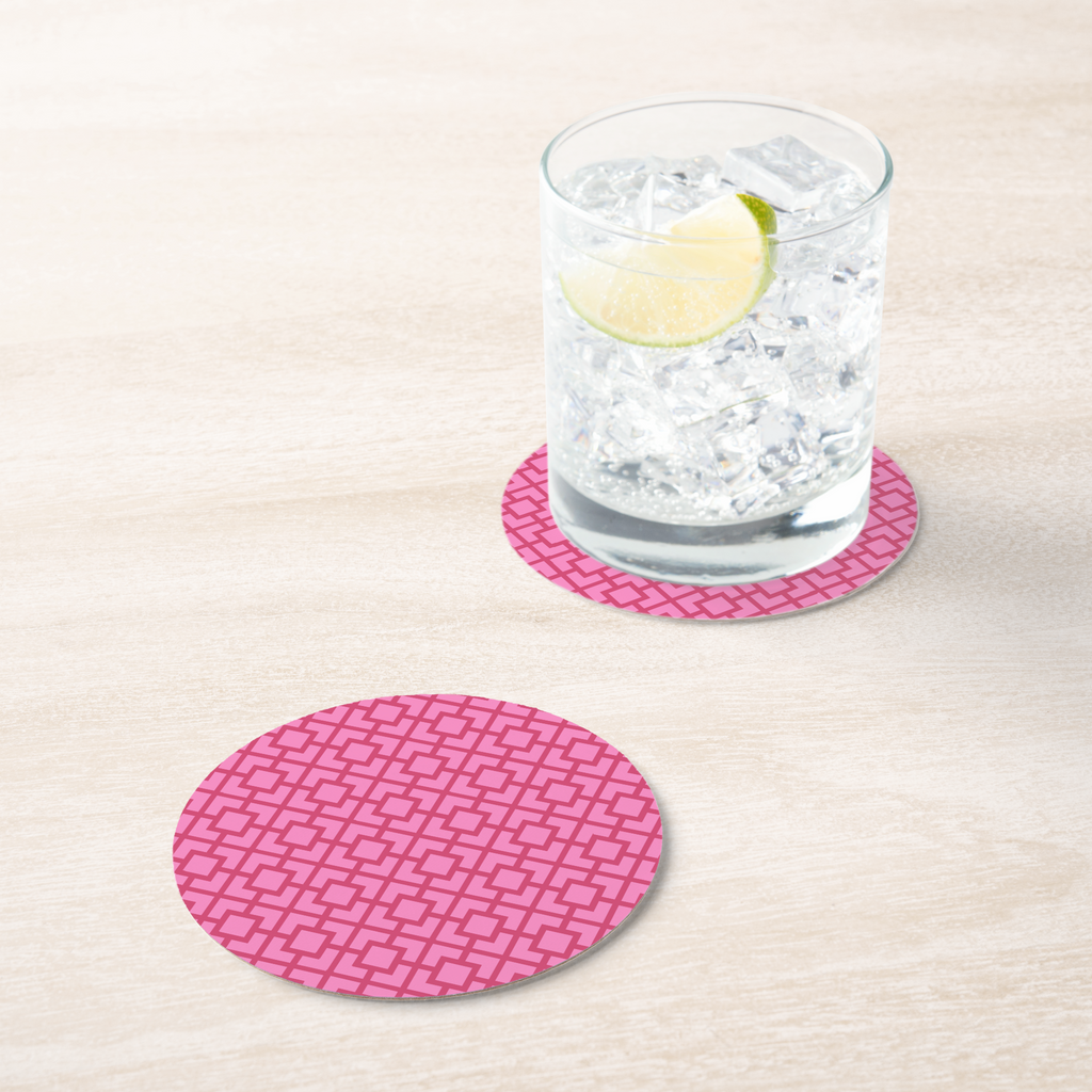 La Chinoiserie Rouge Fretwork paper coaster under an iced drink on pale wood