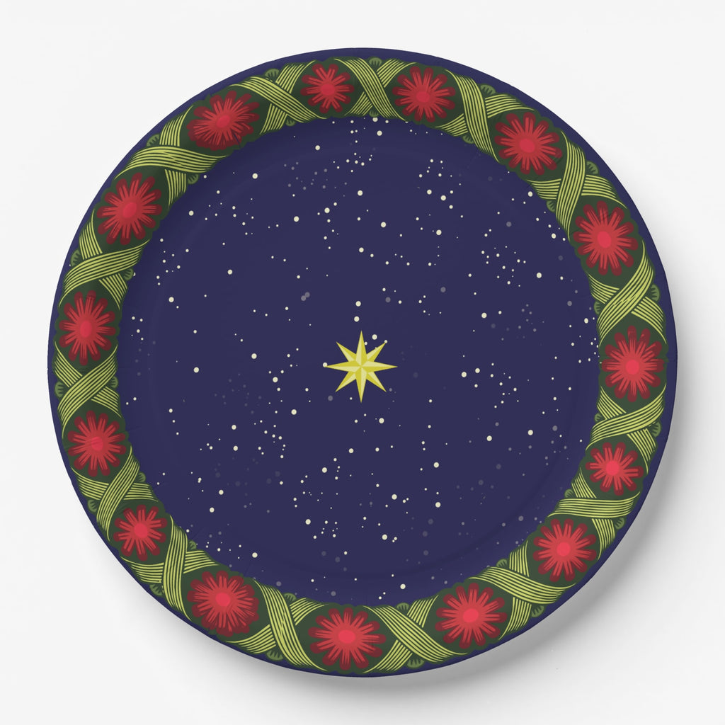 Noël La Tresse 9″ dinner plate — gold star on a navy night sky inside a braided green band with red rosettes