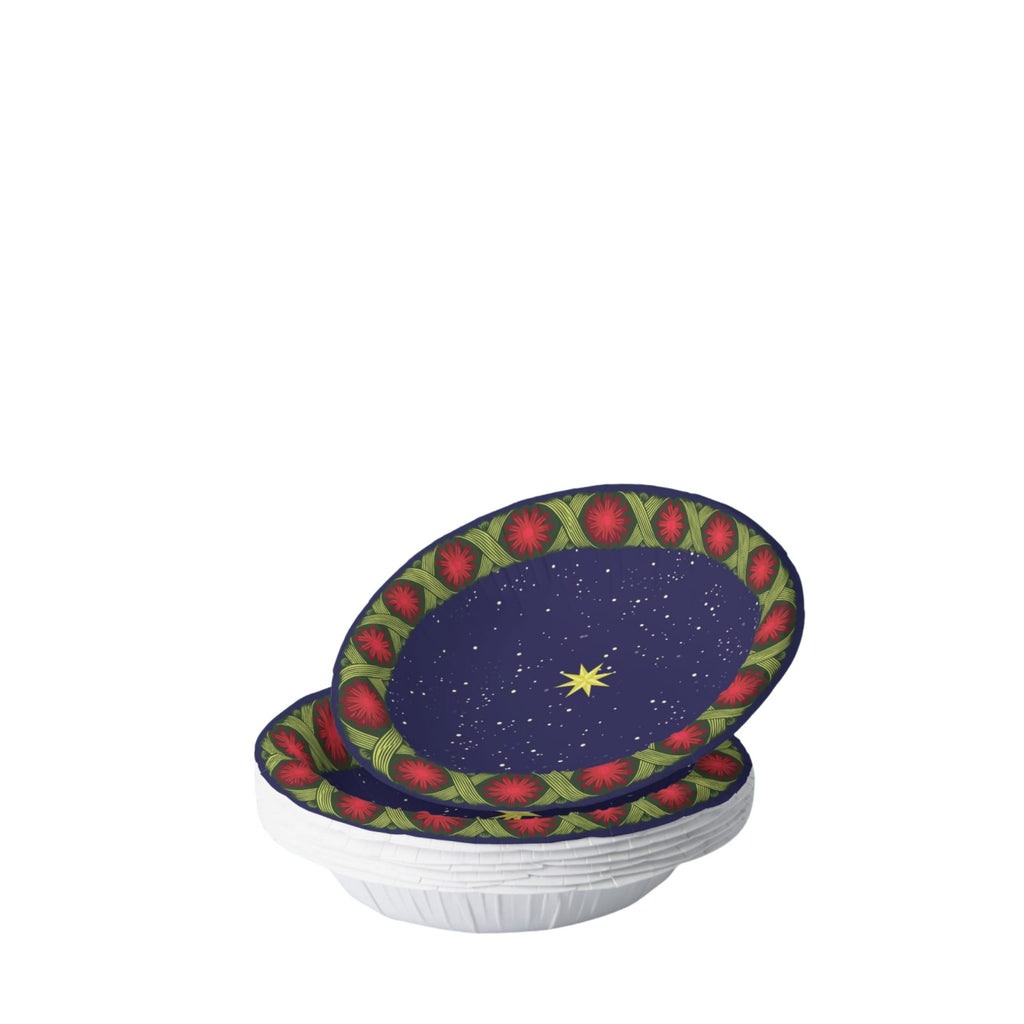 Noël La Tresse bowl on a set table — gold star on navy inside a braided green band with red rosettes