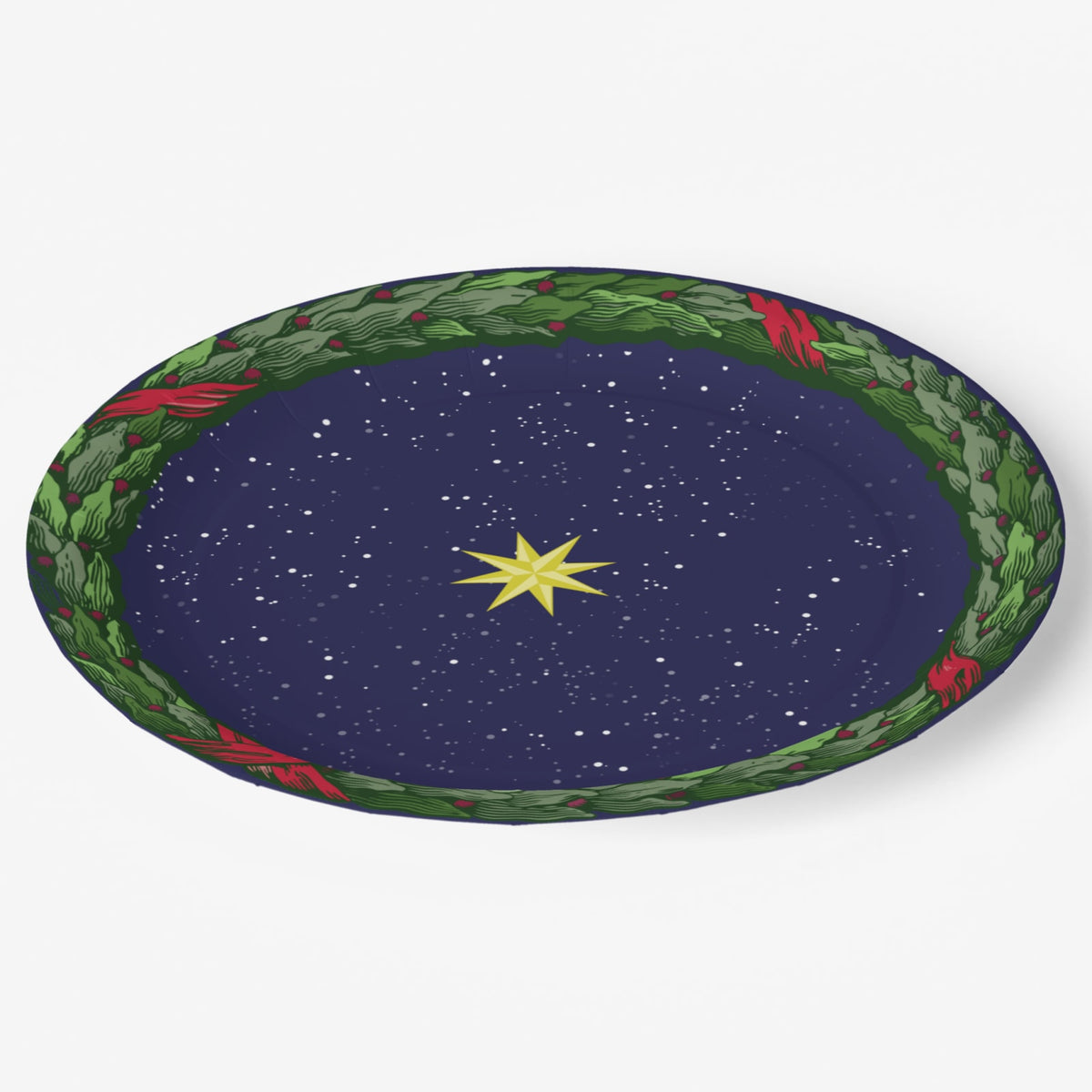 Noël La Nuit Étoilée dinner plate at an angle — laurel wreath rim over a starry navy ground