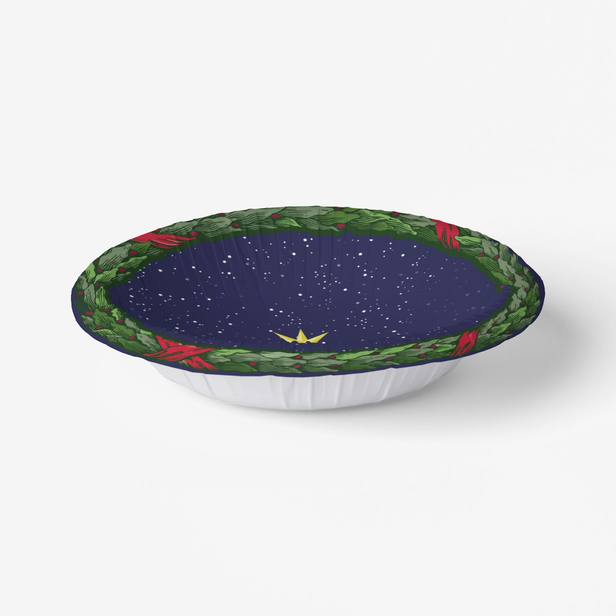 Noël La Nuit Étoilée bowl at an angle, its fluted wall visible — laurel wreath over a starry navy ground