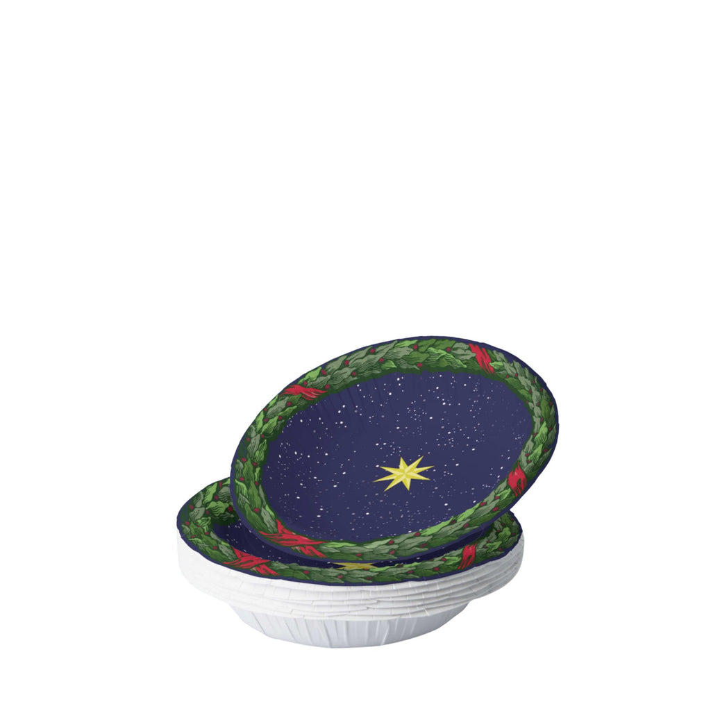 Noël La Nuit Étoilée bowl on a set table — gold star on navy inside a green laurel wreath