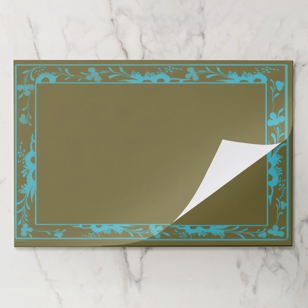La Chinoiserie Bordure placemat pad in Teal, sheet lifted from the pad