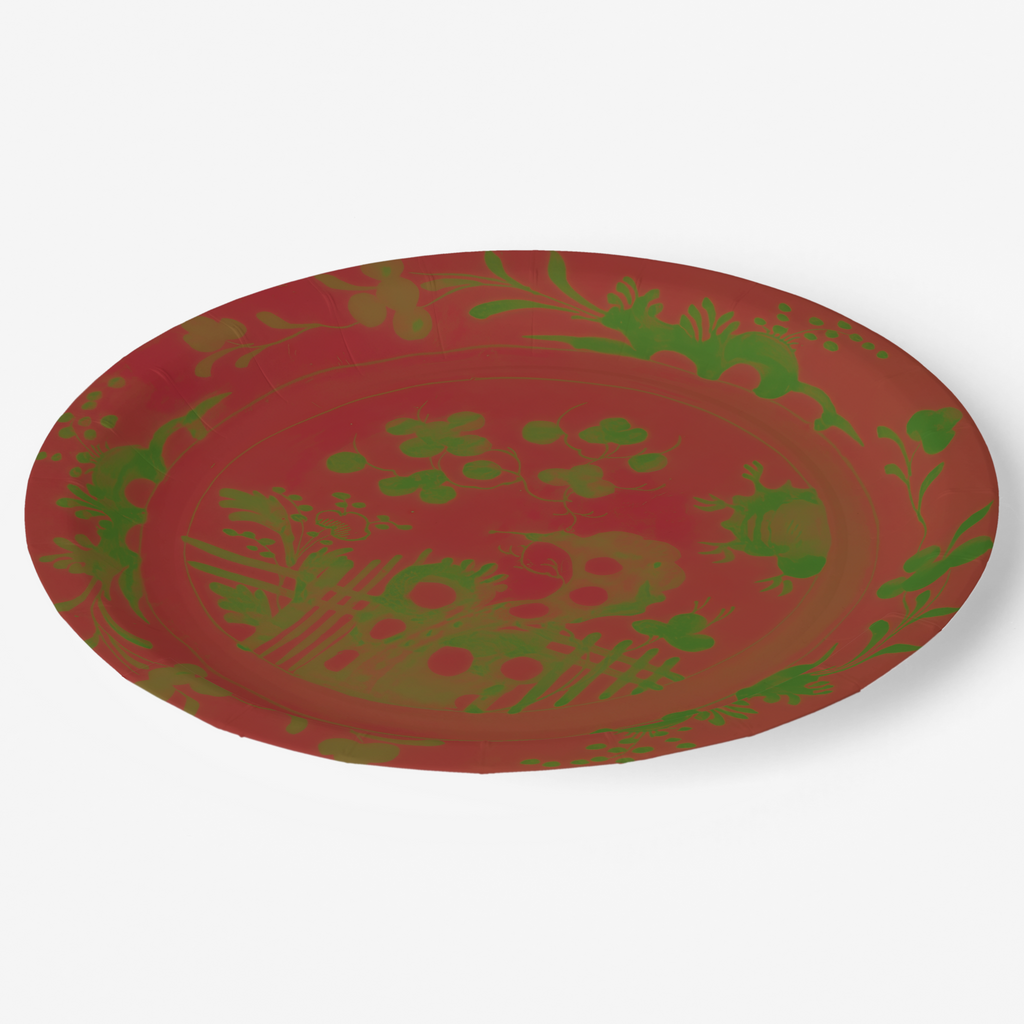 La Chinoiserie Noël paper plate seen at an angle — green garden scene on lacquer red